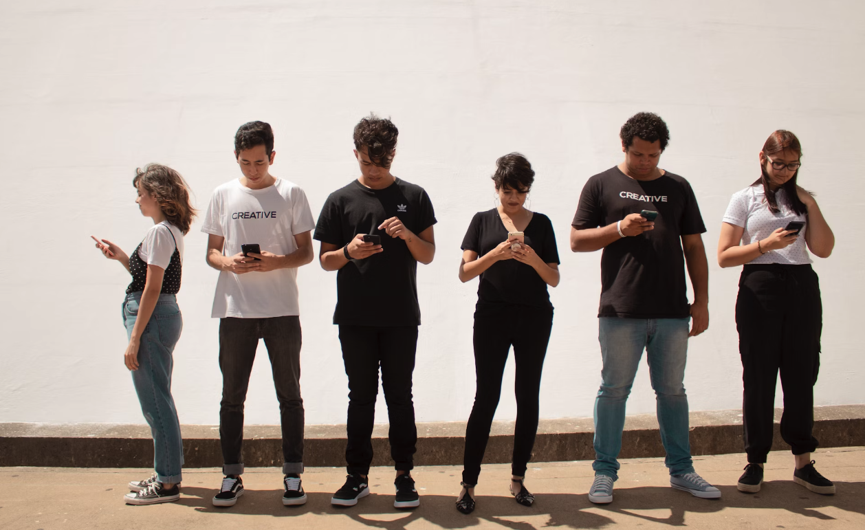 Young people looking at their phones